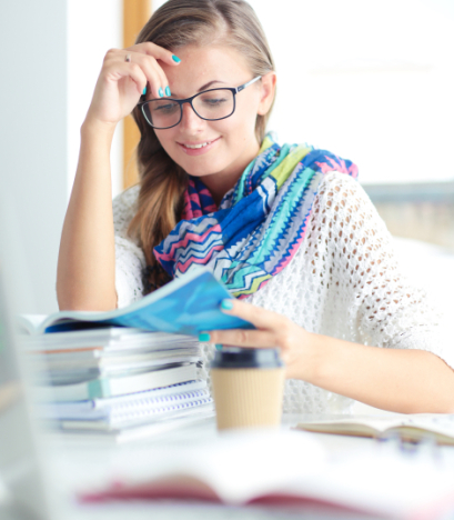 young-woman-sitting-desk-among-books-student-470x705