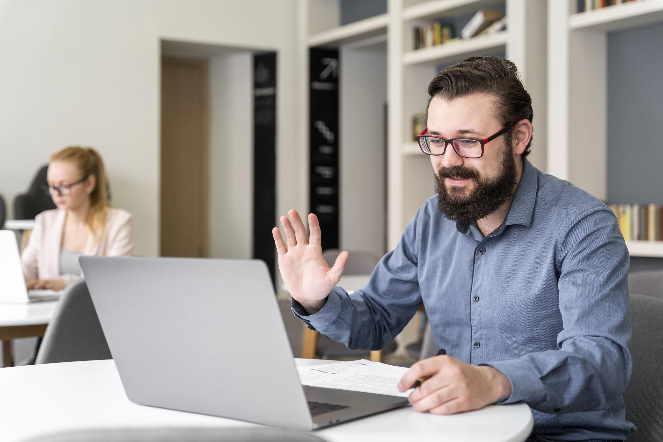 man-waving-laptop-medium-shot