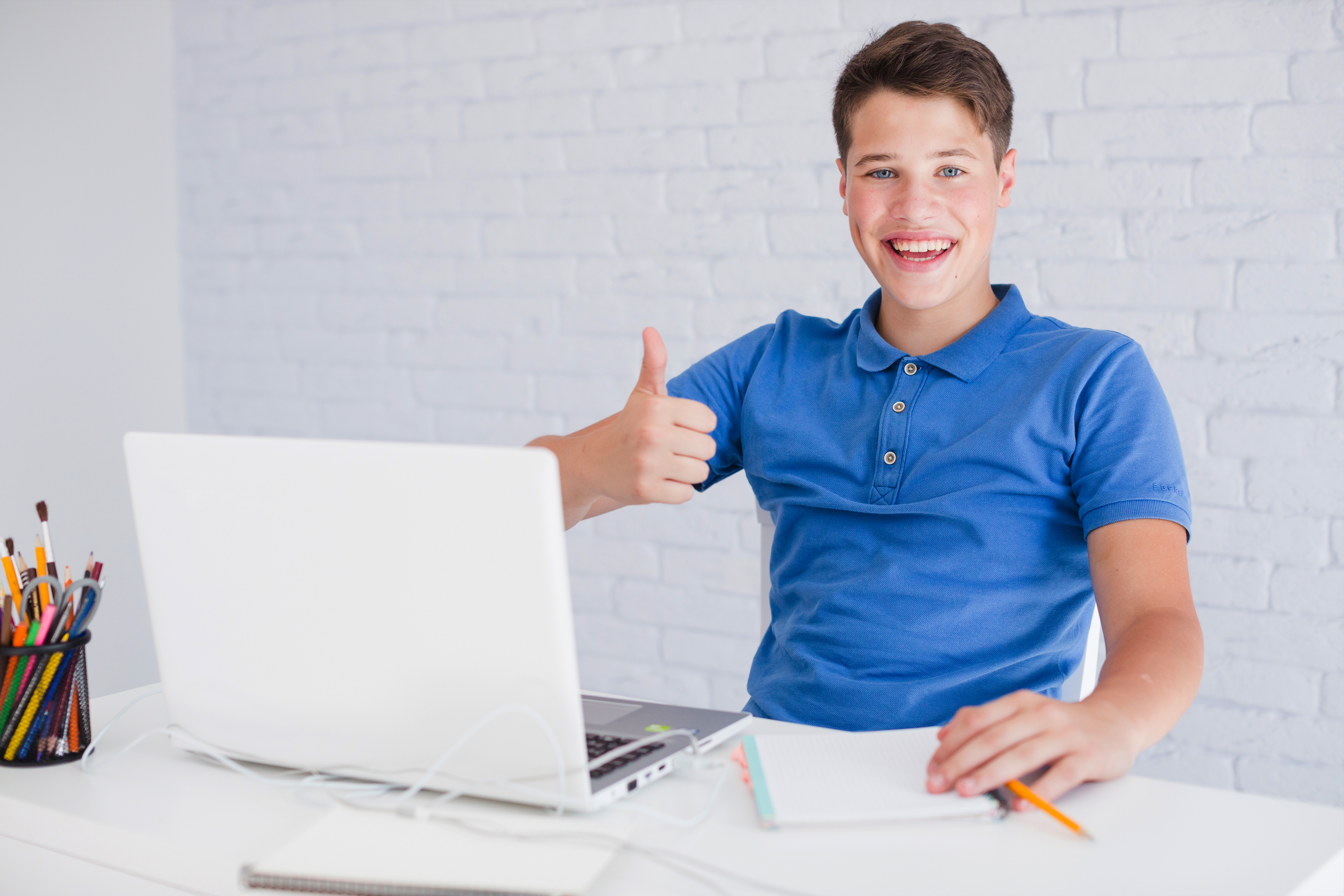 young-man-listening-music-headphones-while-working